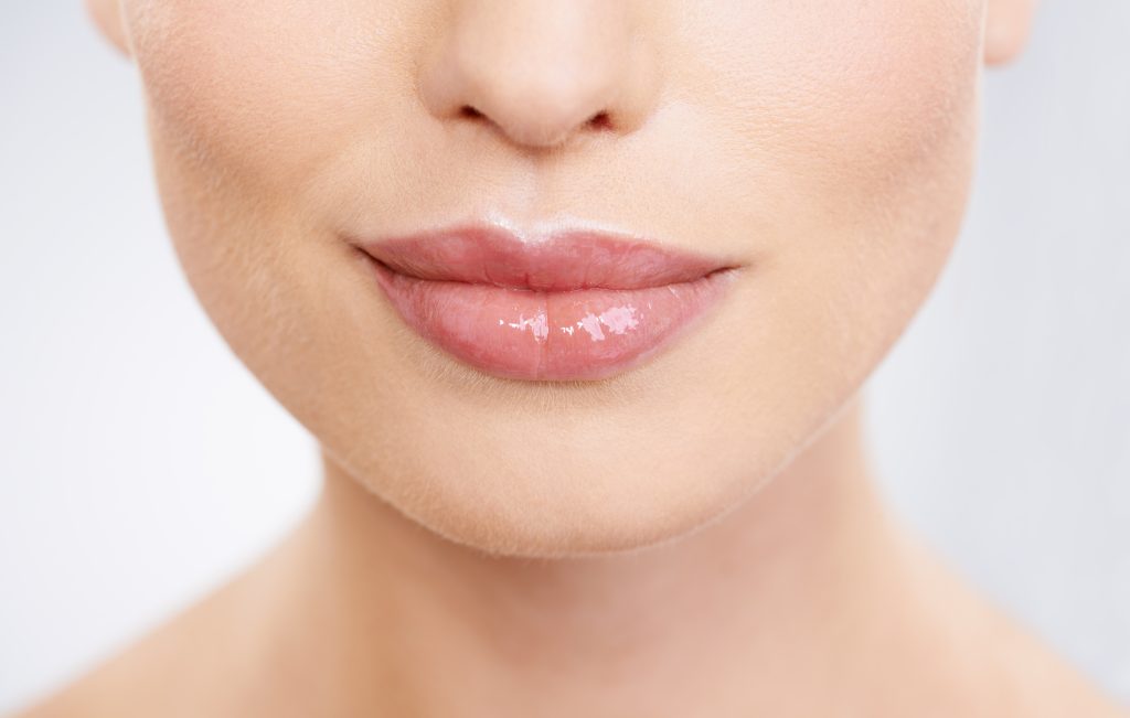Close‑up of elegant lips with hyaluronic acid lip filler focus and Forte Faces branding in Conshohocken.